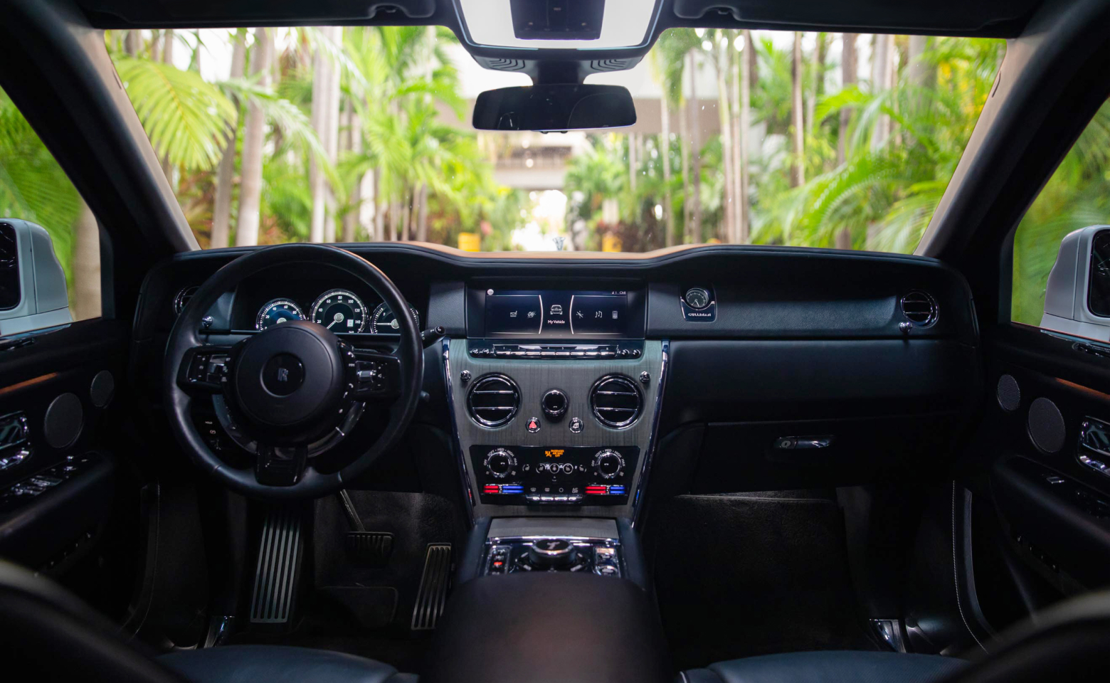 Interior view of a luxury vehicle available for rent from RealCar car rental in Miami, showcasing plush leather seats, advanced dashboard features, and refined interior detailing